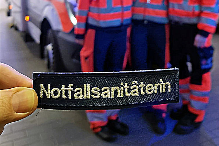 Besticktes Etikett mit der Aufschrift: Notfallsanitäterin